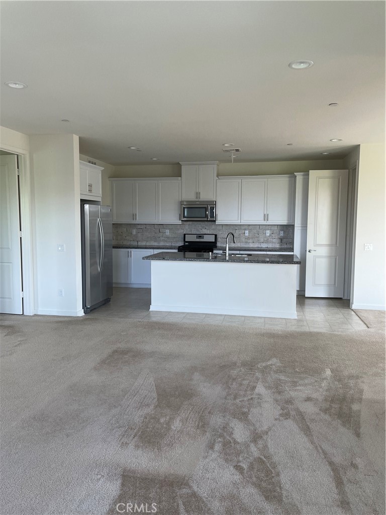 609 Trailblaze Irvine, CA 92618 - Photo 8 of 29 a large kitchen with a stove a refrigerator and a sink