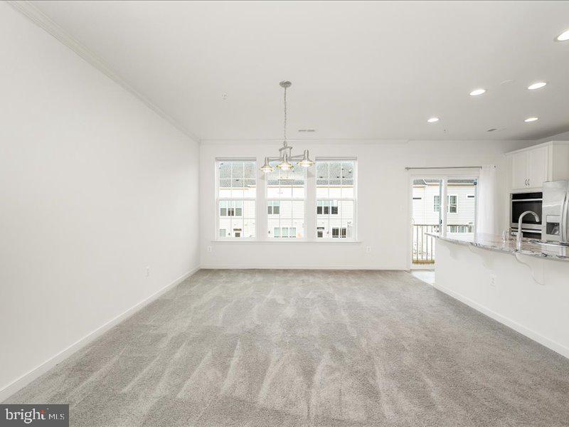 667 East Church Street, Unit B Frederick, MD 21701 - Photo 13 of 51 a view of a kitchen with furniture and chandelier
