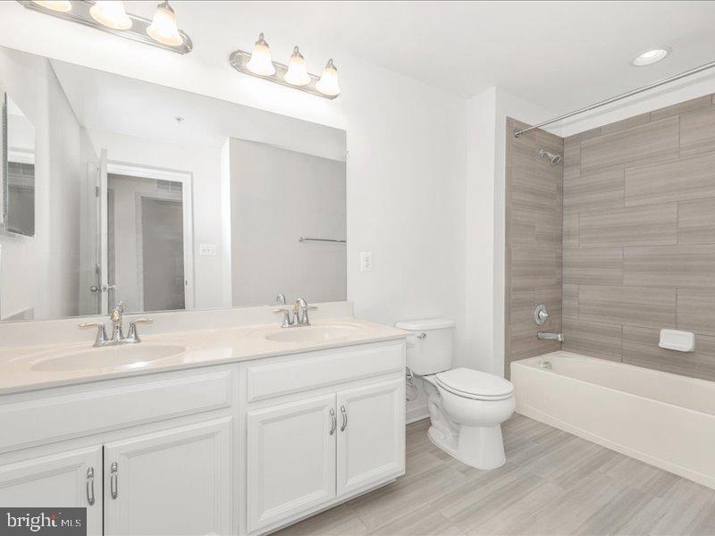 667 East Church Street, Unit B Frederick, MD 21701 - Photo 33 of 51 a bathroom with a double vanity sink a toilet and a bathtub
