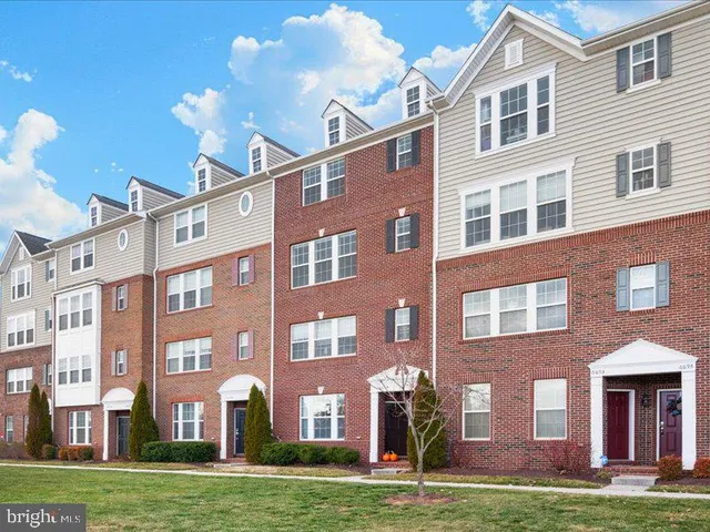 a view of a brick building next to a yard
