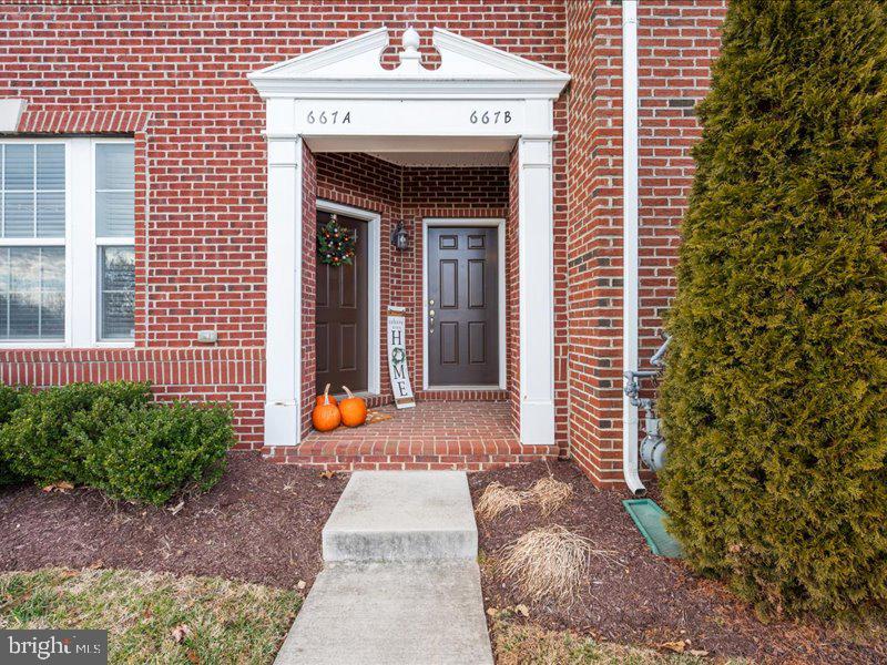 667 East Church Street, Unit B Frederick, MD 21701 - Photo 6 of 51 a view of a brick house with potted plants