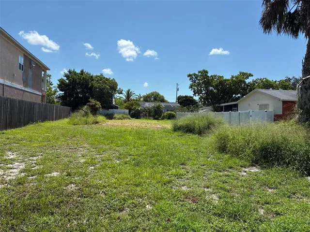 a view of a garden with a building in the background