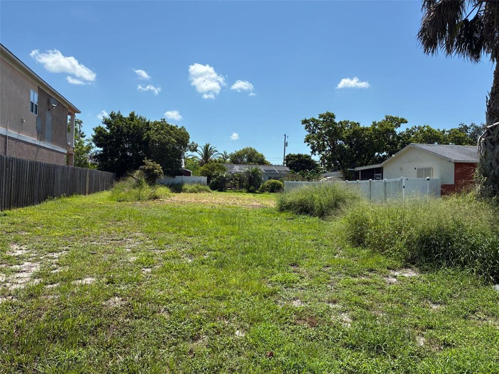 a view of a garden with a building in the background