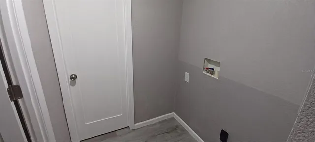 a view of a room that has a window and bed in it