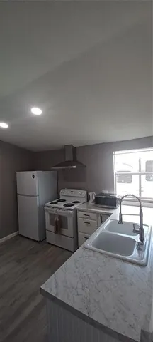 a kitchen with white cabinets and white appliances