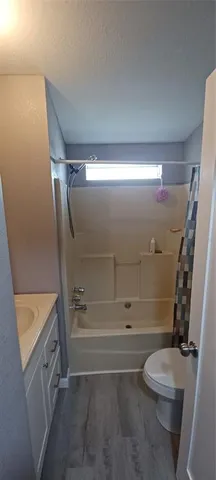 a bathroom with a tub sink and mirror