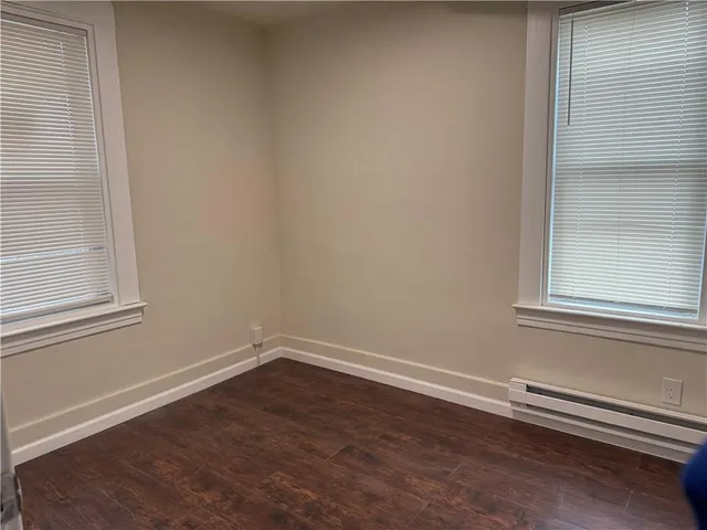 an empty room with wooden floor and closet