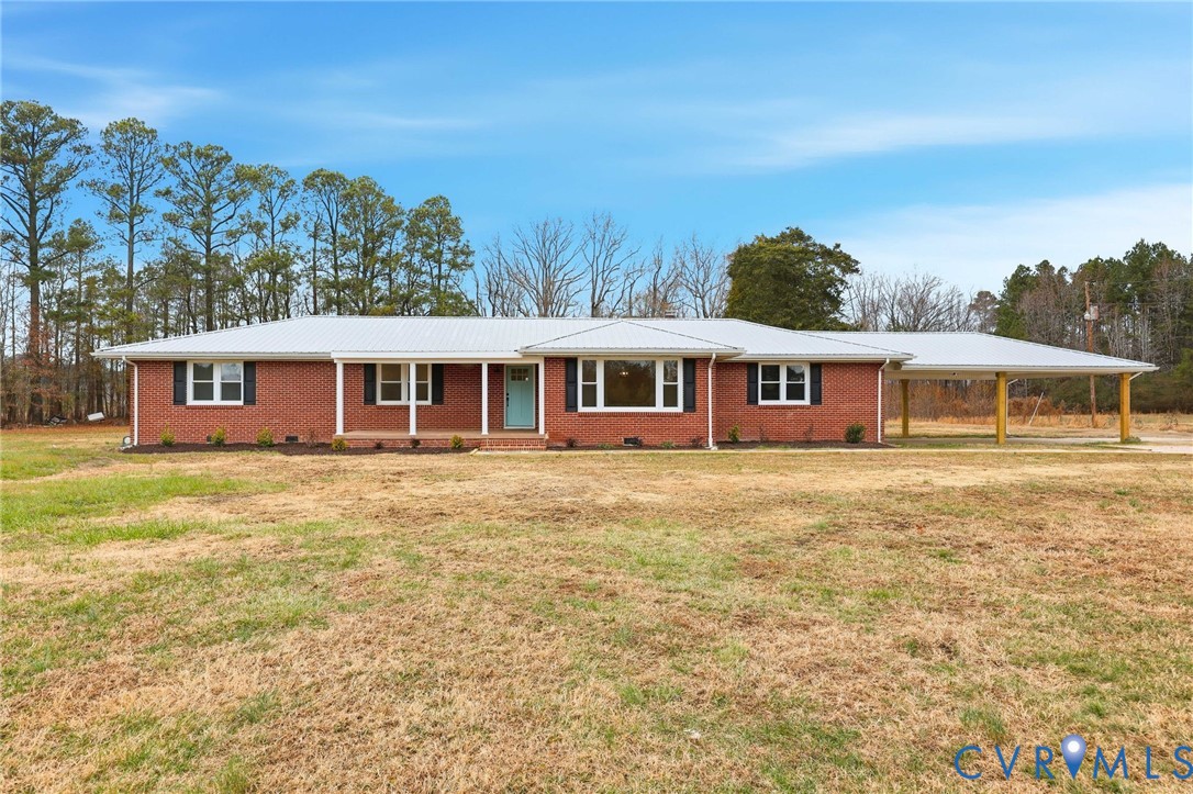 8202 Vaughan Road Petersburg, VA 23805 - Photo 1 of 31 a front view of a house with a garden