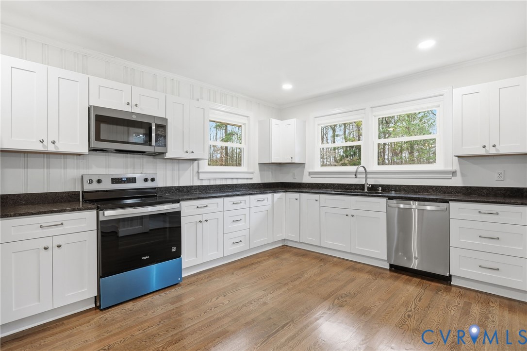 8202 Vaughan Road Petersburg, VA 23805 - Photo 17 of 31 a kitchen with granite countertop wooden cabinets and a stove