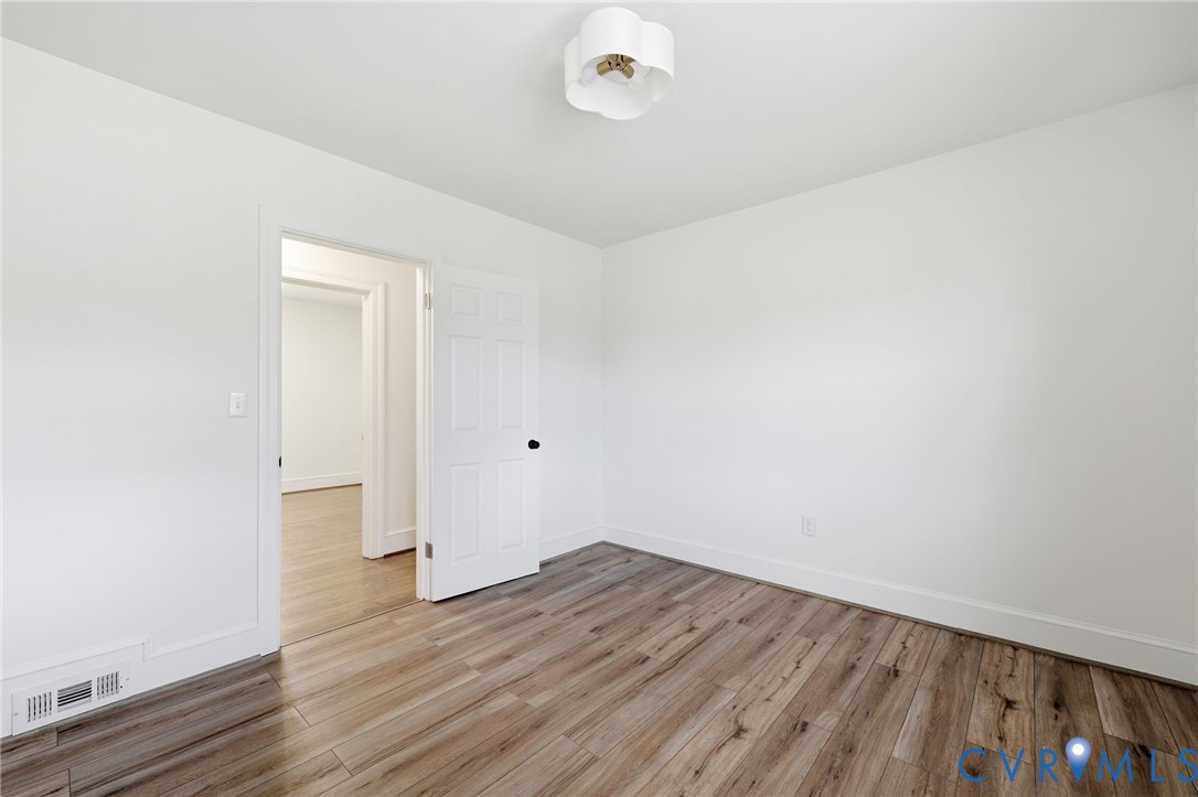 8202 Vaughan Road Petersburg, VA 23805 - Photo 21 of 31 a view of an empty room with wooden floor