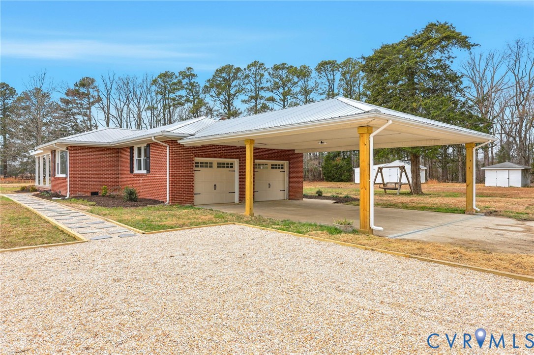 8202 Vaughan Road Petersburg, VA 23805 - Photo 3 of 31 a backyard of a house with table and chairs under an umbrella