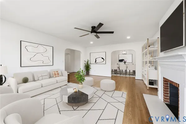 an empty room with wooden floor chandelier and windows