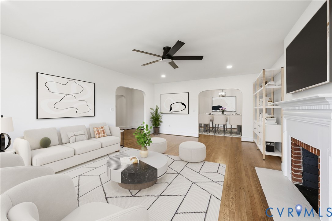 8202 Vaughan Road Petersburg, VA 23805 - Photo 8 of 31 a living room with furniture a fireplace and a flat screen tv