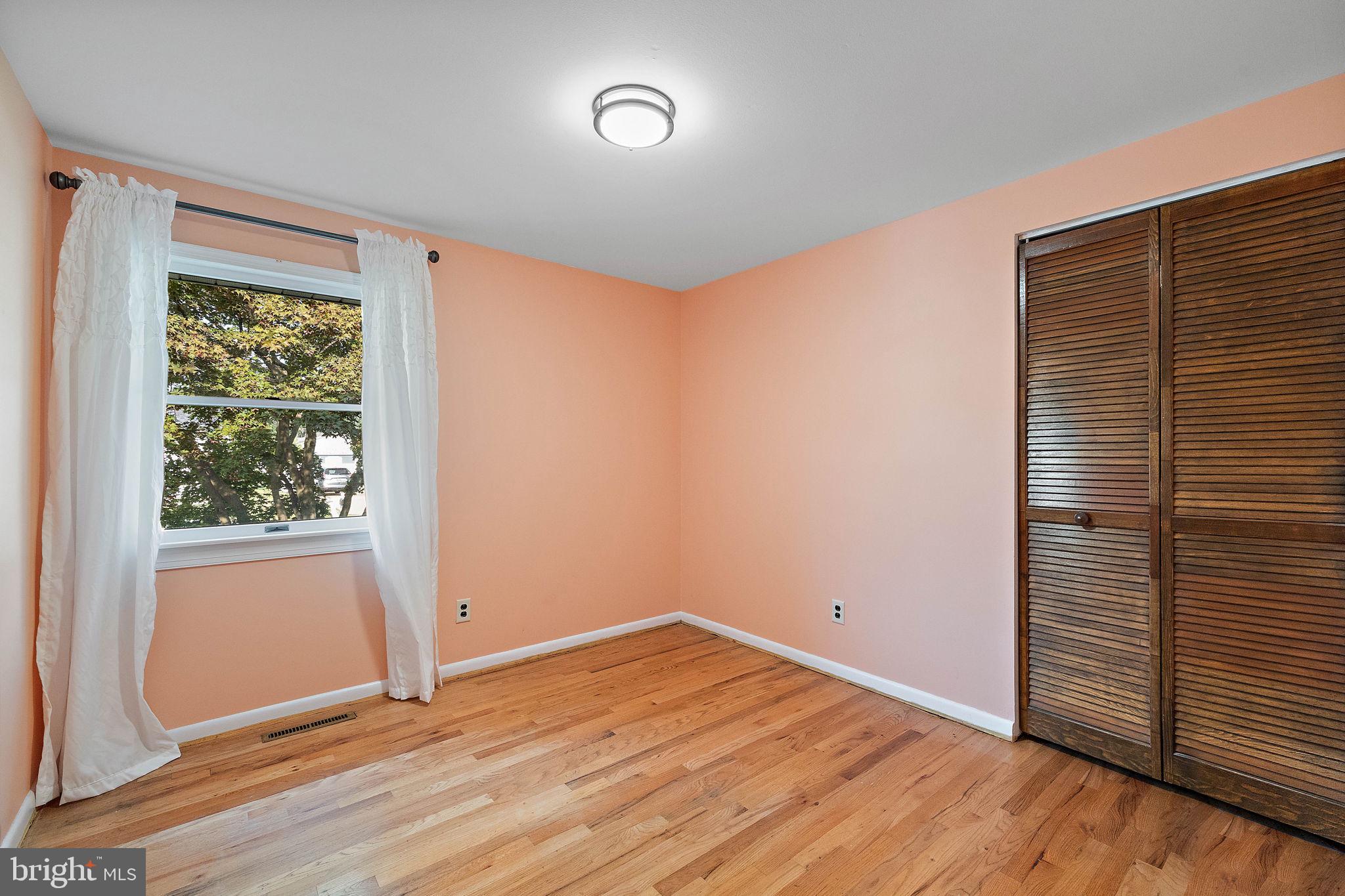 105 Eastfield Road Newark, DE 19713 - Photo 11 of 26 an empty room with wooden floor and windows