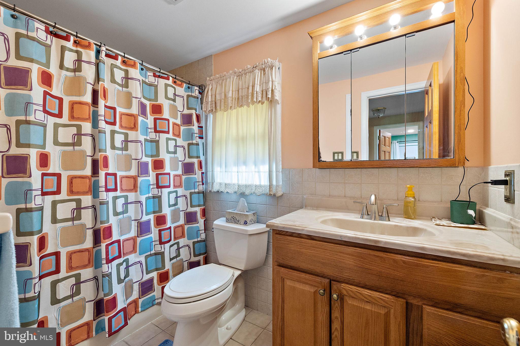 105 Eastfield Road Newark, DE 19713 - Photo 12 of 26 a bathroom with a sink a toilet and shower curtain