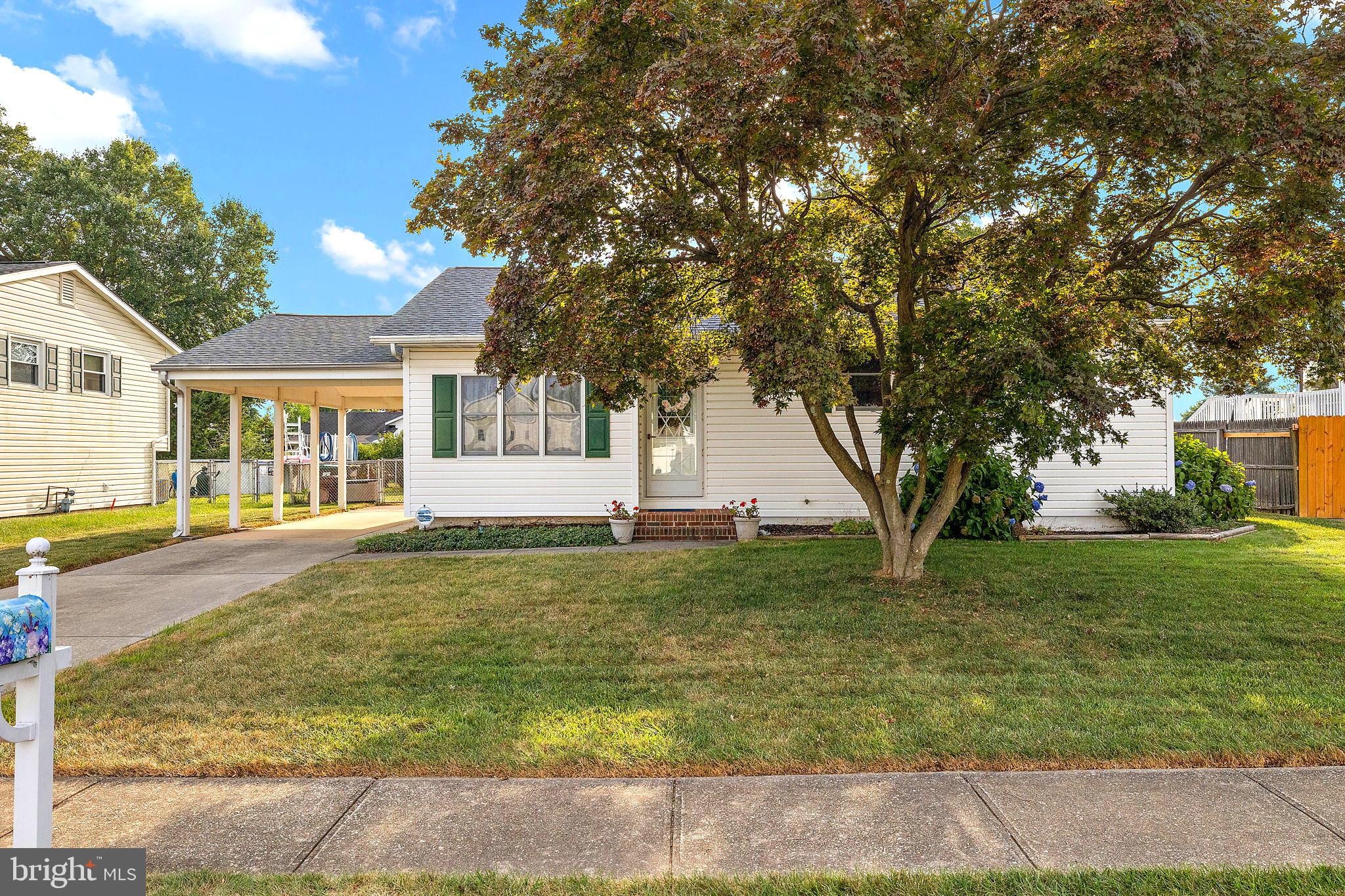 105 Eastfield Road Newark, DE 19713 - Photo 2 of 26 a view of a white house next to a yard with big trees