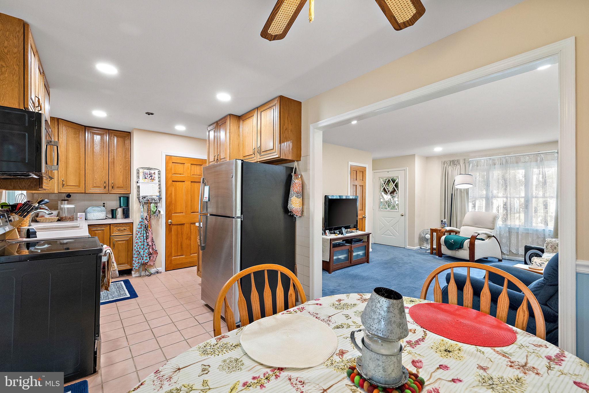 105 Eastfield Road Newark, DE 19713 - Photo 7 of 26 a dining room with furniture a window and kitchen view