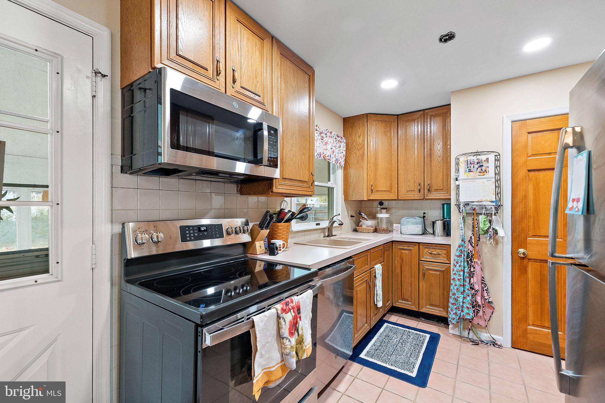 105 Eastfield Road Newark, DE 19713 - Photo 8 of 26 a kitchen with stainless steel appliances granite countertop a stove a sink and a microwave