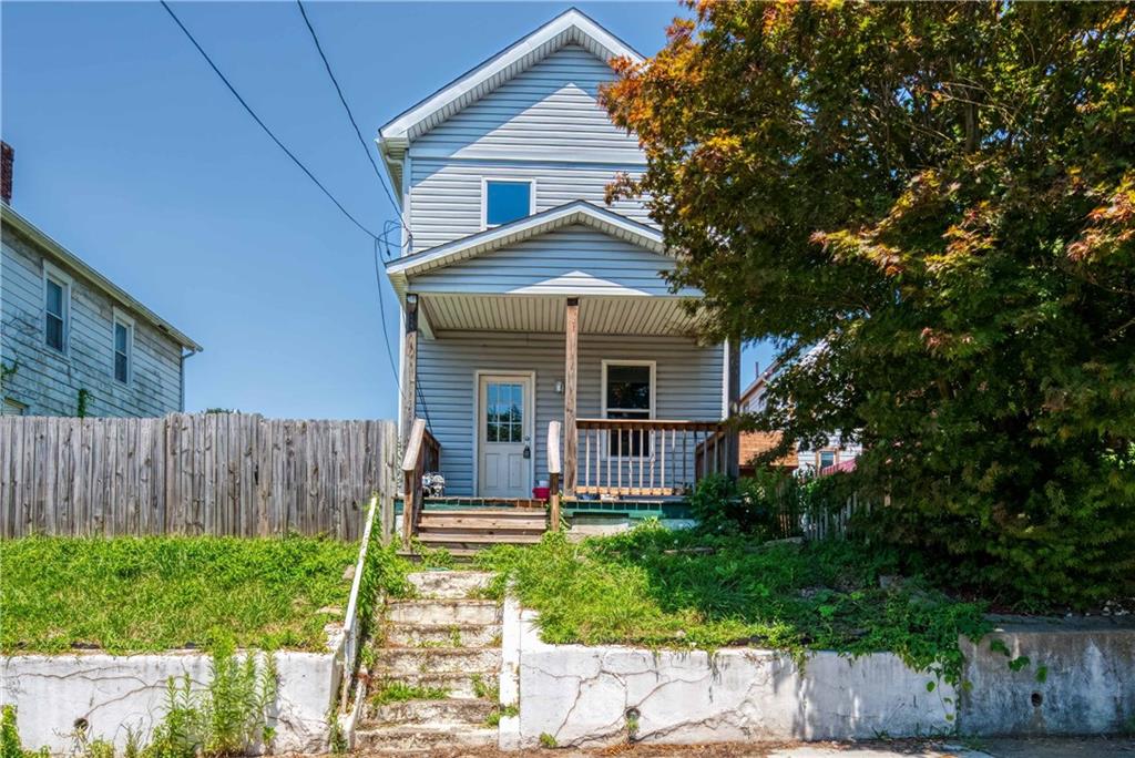 a front view of house with a garden