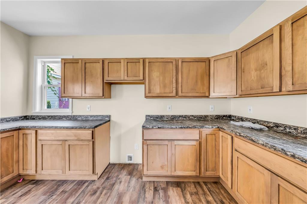 522 Jefferson Street Rochester, PA 15074 - Photo 13 of 28 a kitchen with granite countertop wooden cabinets and a stove