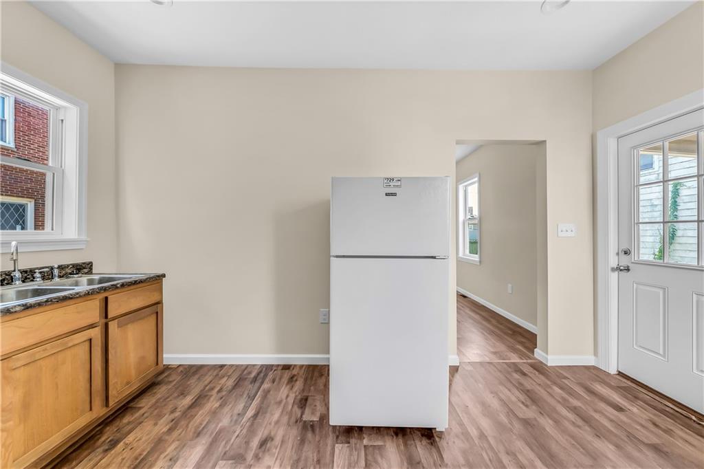 522 Jefferson Street Rochester, PA 15074 - Photo 14 of 28 a view of a kitchen with wooden floor and electronic appliances