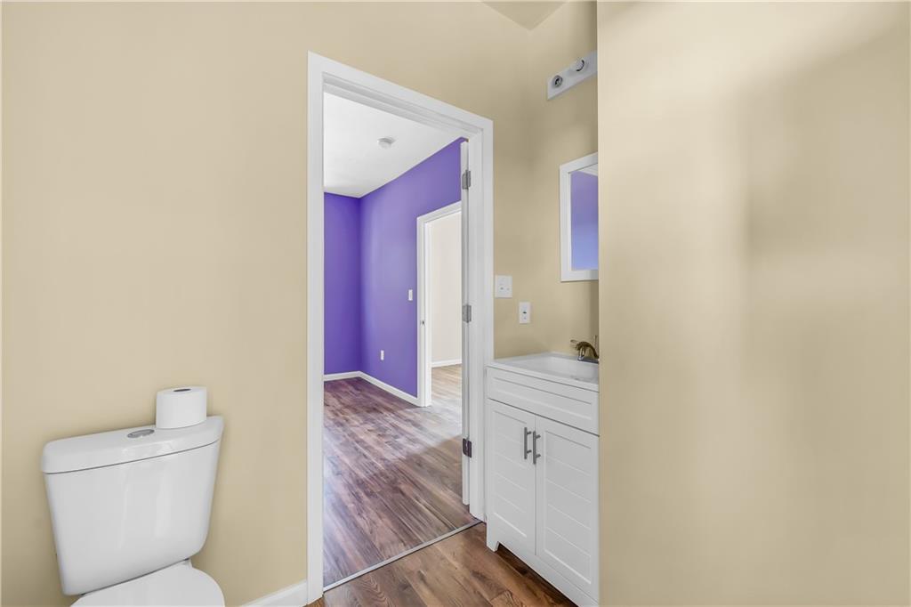 522 Jefferson Street Rochester, PA 15074 - Photo 19 of 28 a bathroom with a toilet sink and mirror