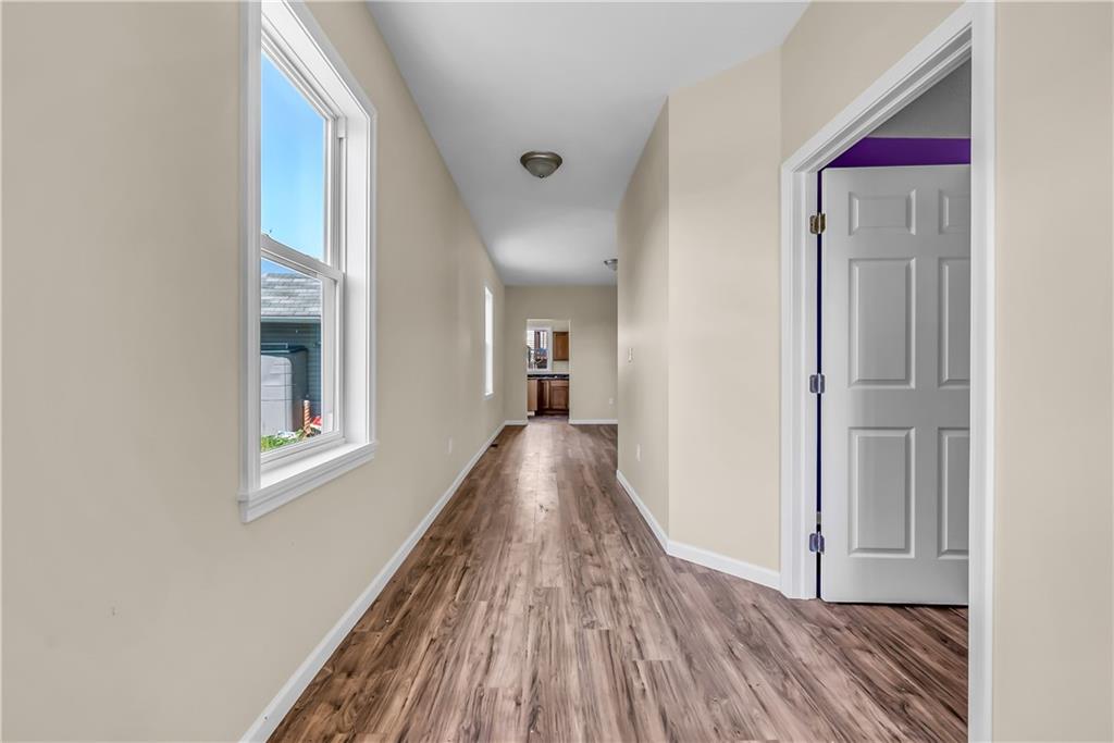 522 Jefferson Street Rochester, PA 15074 - Photo 4 of 28 a view of a hallway with wooden floor and staircase