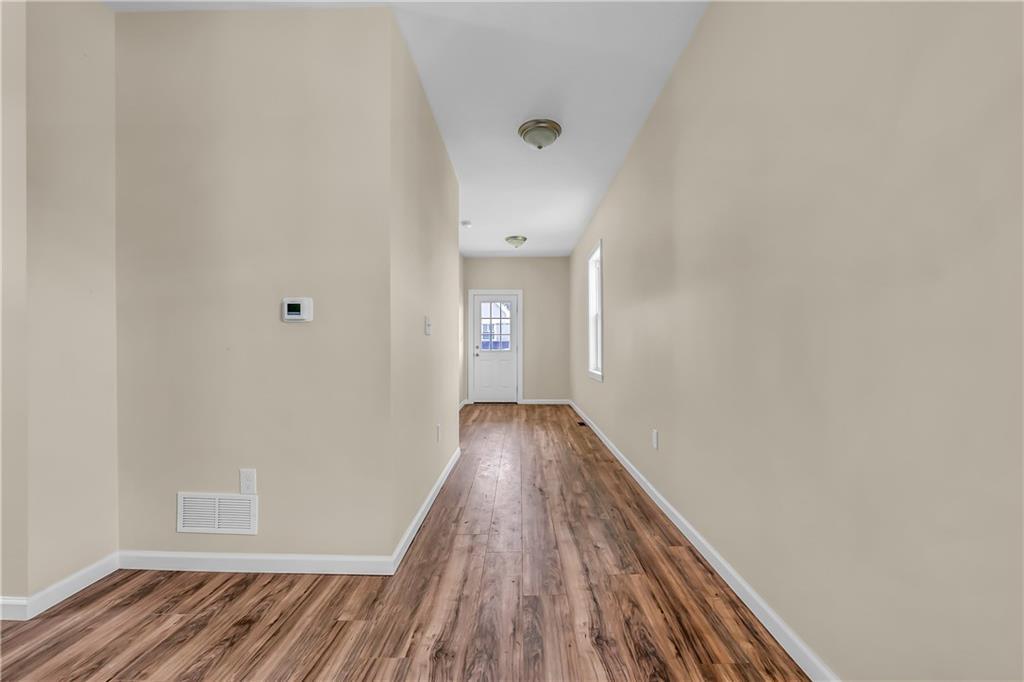 522 Jefferson Street Rochester, PA 15074 - Photo 6 of 28 a view of a hallway with wooden floor
