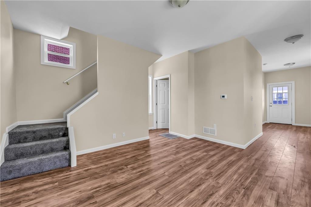 522 Jefferson Street Rochester, PA 15074 - Photo 7 of 28 an empty room with wooden floor and windows