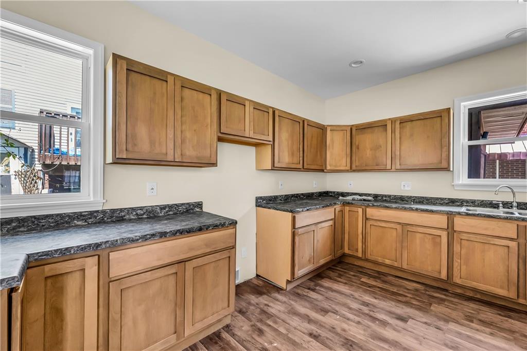 522 Jefferson Street Rochester, PA 15074 - Photo 9 of 28 a kitchen with stainless steel appliances granite countertop a sink stove and cabinets
