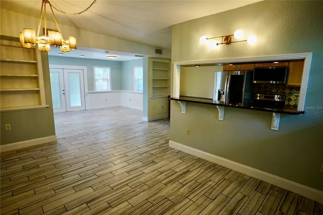 a view of a livingroom with furniture wooden floor and window
