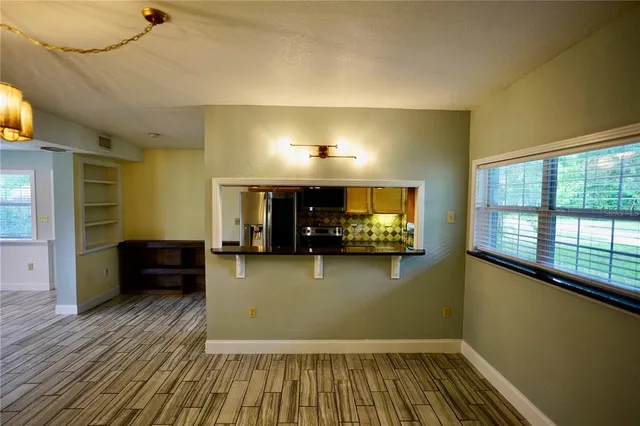 a view of a livingroom with furniture and a flat screen tv