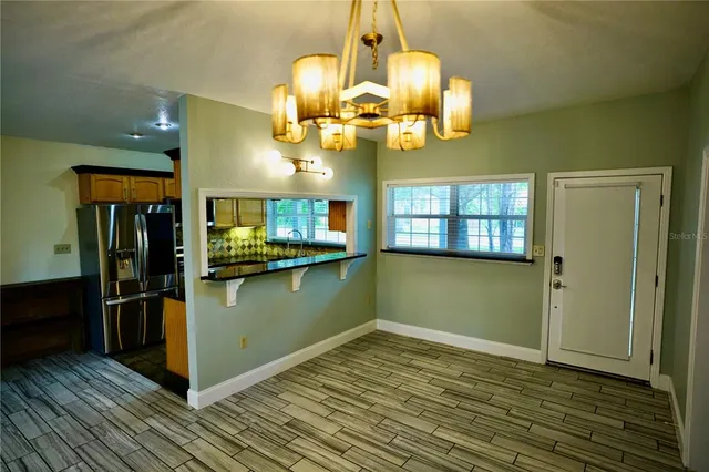 a kitchen with stainless steel appliances granite countertop a refrigerator and a stove top oven