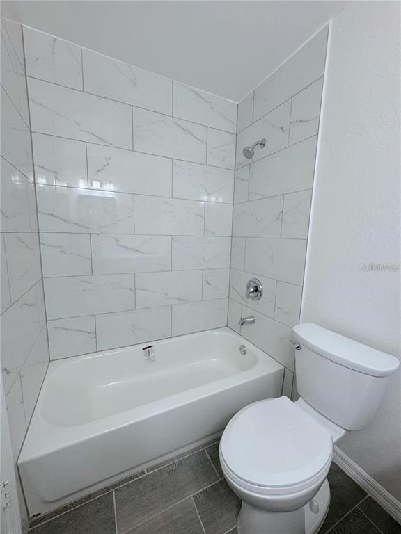 1013 South Hiawassee Road, Unit 3635 Orlando, FL 32835 - Photo 16 of 18 a bathroom with a toilet and bathtub