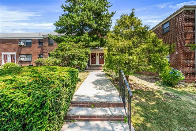 a view of a pathway with a house in the background