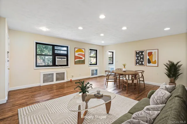 a living room with furniture wooden floor and dining table