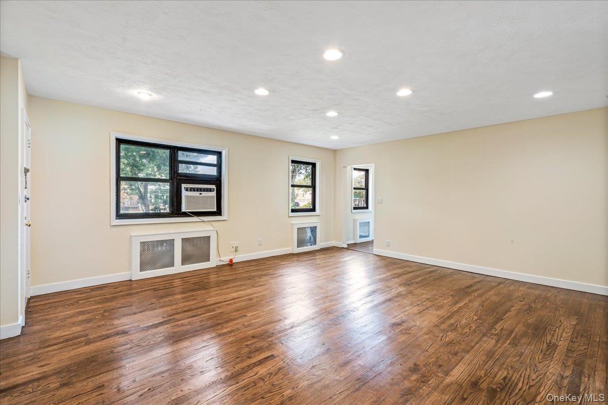 16-37 Utopia Parkway, Unit 233 Queens, NY 11357 - Photo 3 of 16 Living room with wood finished floors, and recessed lighting
