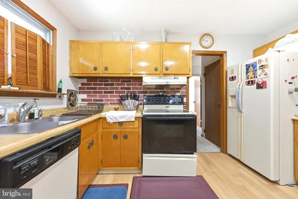 a kitchen with a refrigerator and a sink