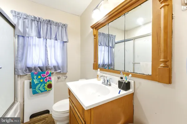 a bathroom with a sink a toilet and a mirror