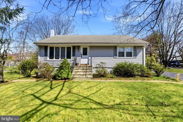 a front view of a house with yard and green space