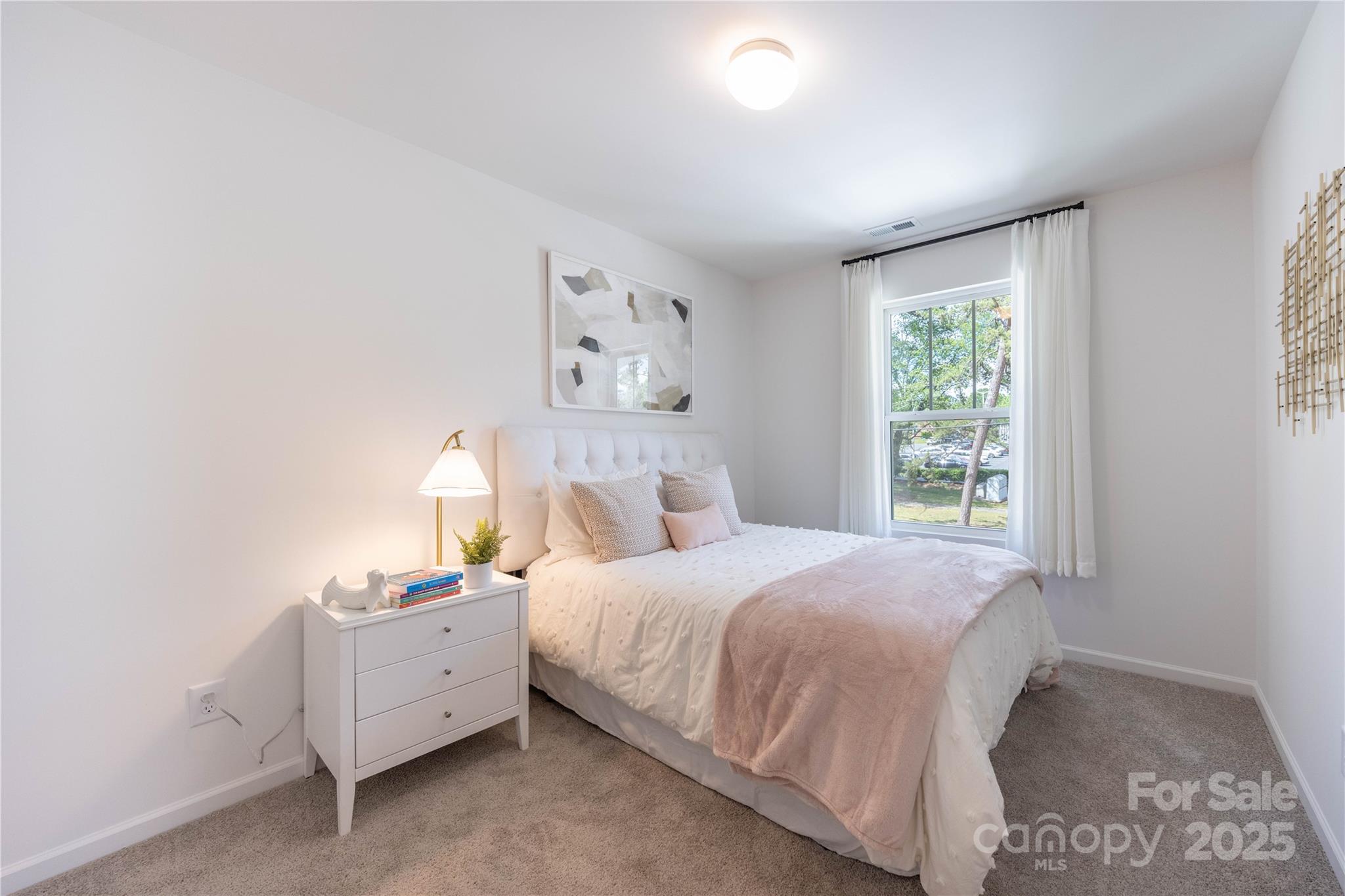 3014 Springvale Street, Unit 21 Charlotte, NC 28208 - Photo 8 of 12 a bedroom with a bed and a window