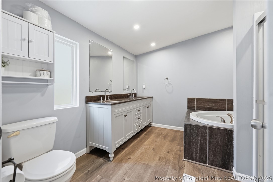 78 Georgia Way Cameron, NC 28326 - Photo 12 of 21 a bathroom with a granite countertop toilet sink and mirror