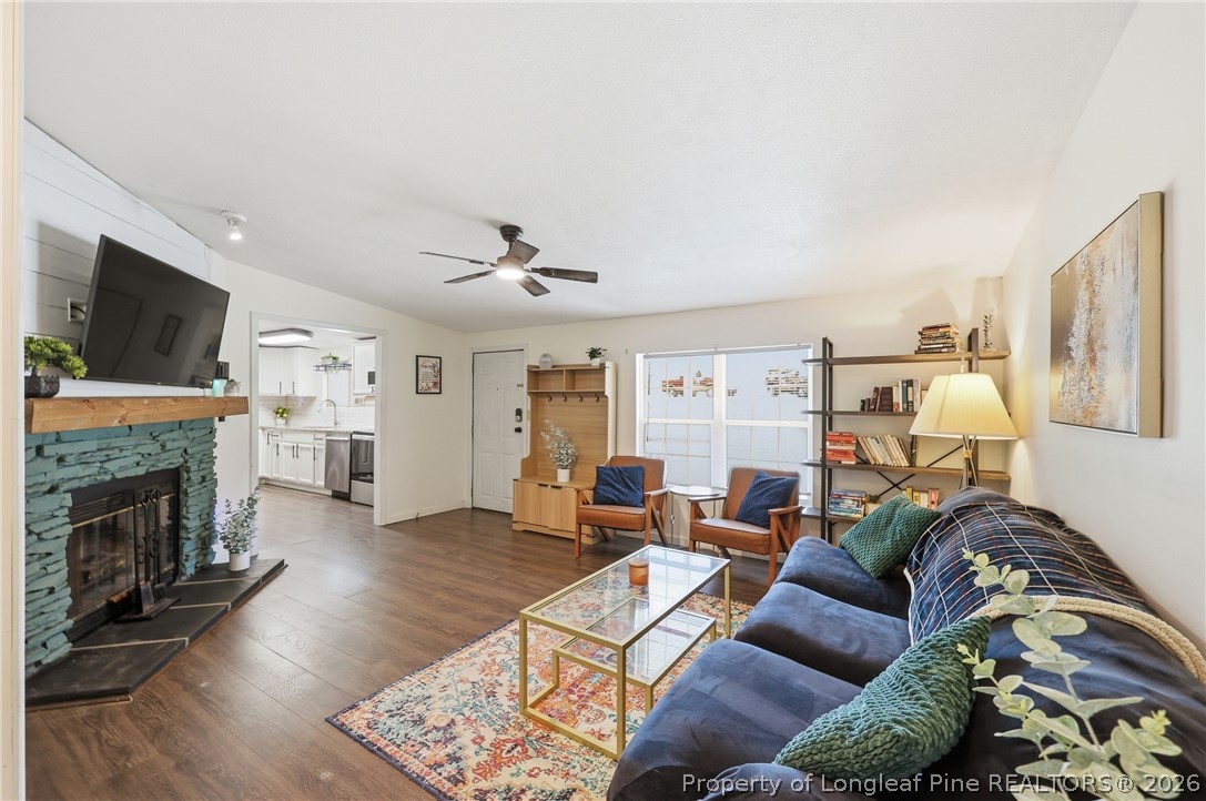 78 Georgia Way Cameron, NC 28326 - Photo 5 of 21 a living room with furniture a fireplace and a flat screen tv
