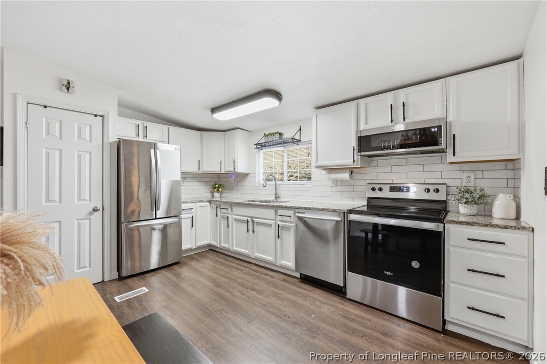 78 Georgia Way Cameron, NC 28326 - Photo 6 of 21 a kitchen with granite countertop a refrigerator stove and sink