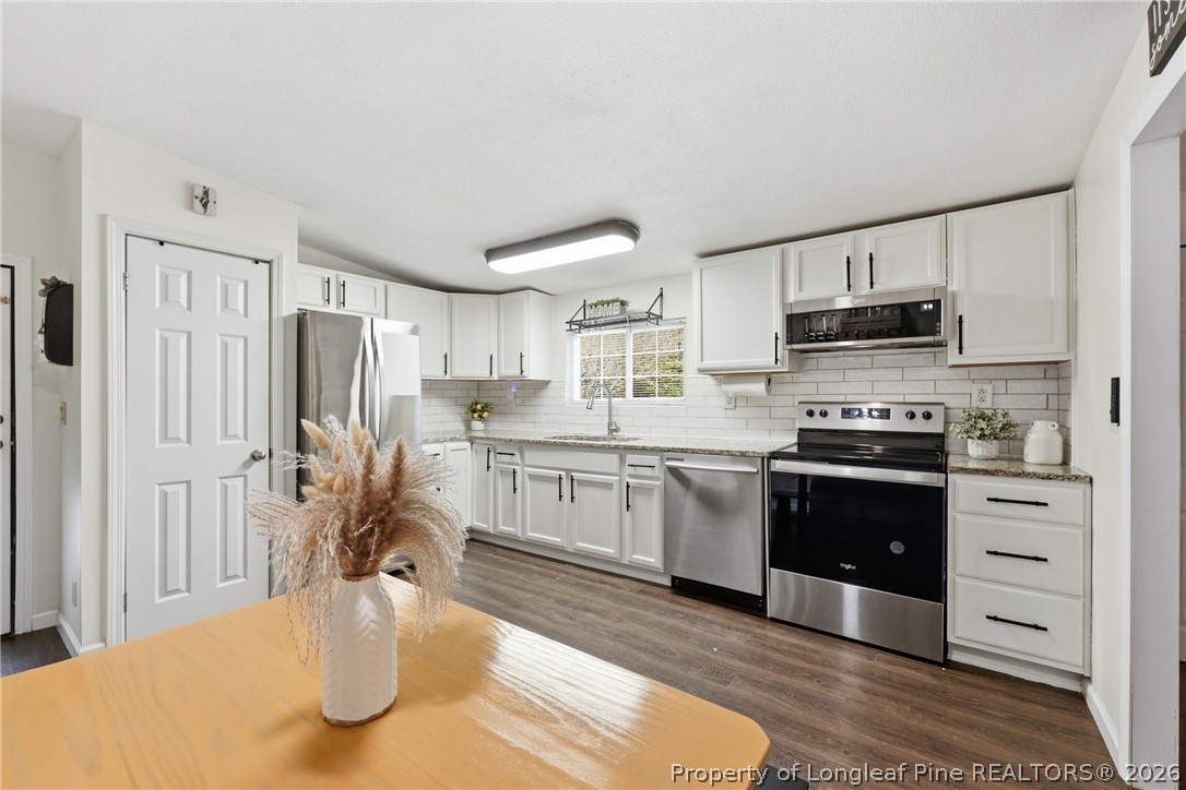 78 Georgia Way Cameron, NC 28326 - Photo 7 of 21 a kitchen with stainless steel appliances granite countertop a refrigerator a stove top oven a sink and dishwasher