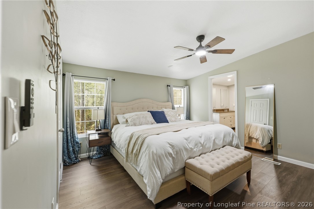 78 Georgia Way Cameron, NC 28326 - Photo 9 of 21 a bedroom with bed and a chandelier