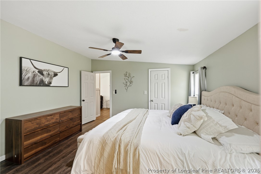 78 Georgia Way Cameron, NC 28326 - Photo 10 of 21 a bedroom with a large bed and a chandelier