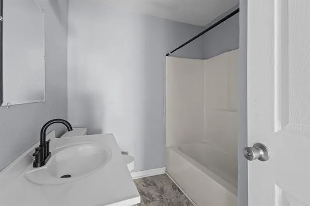 a bathroom with a sink and shower