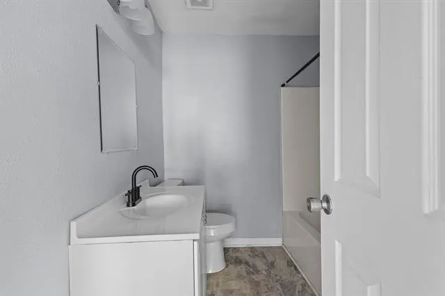 a bathroom with a sink toilet and vanity