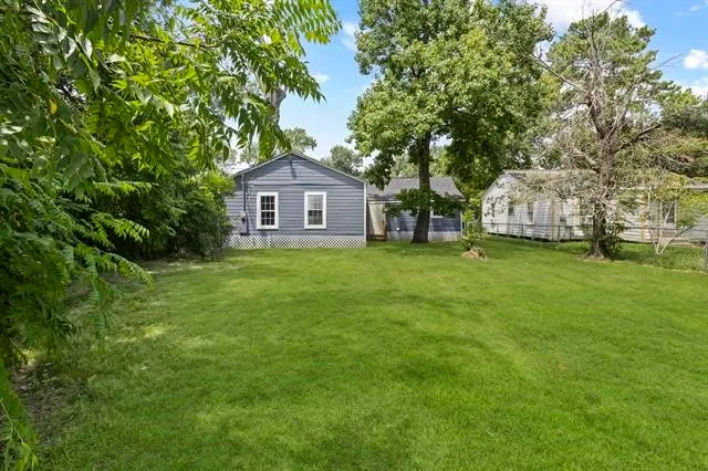 a view of a tree in front of a house with a tree